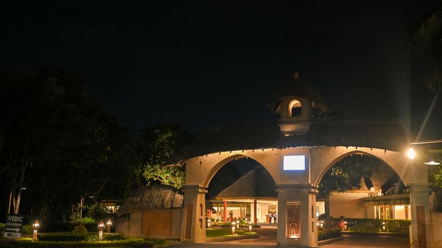 Illuminated double arch way that is made of mud and acts as the entrance to reception at Vedic Village Spa Resort