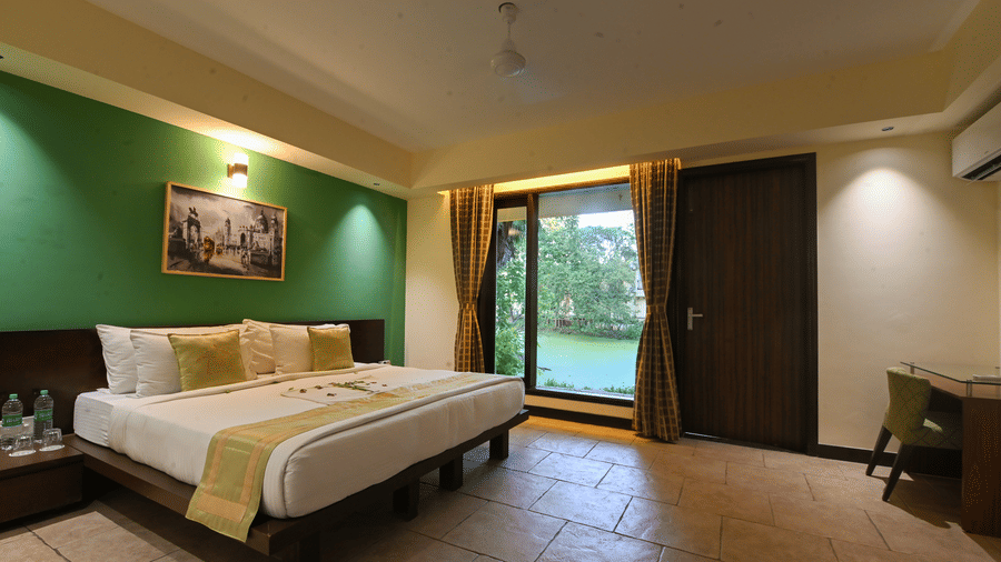 Spacious bedroom with twin beds and garden views at the resort.