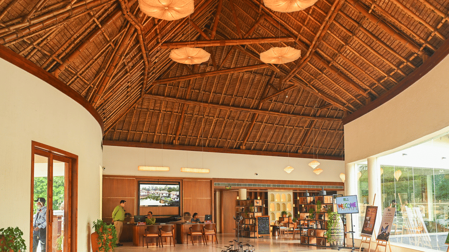 Resort Lobby with wooden decoratives, windows, and doors. | Vedic Village