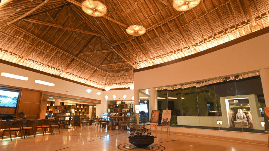 Resort Lobby with wooden decoratives, windows, and doors. | Vedic Village