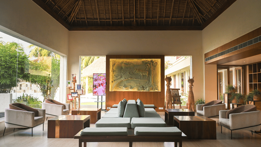 Vedic Village- lobby area with tables, chairs, and cushions.