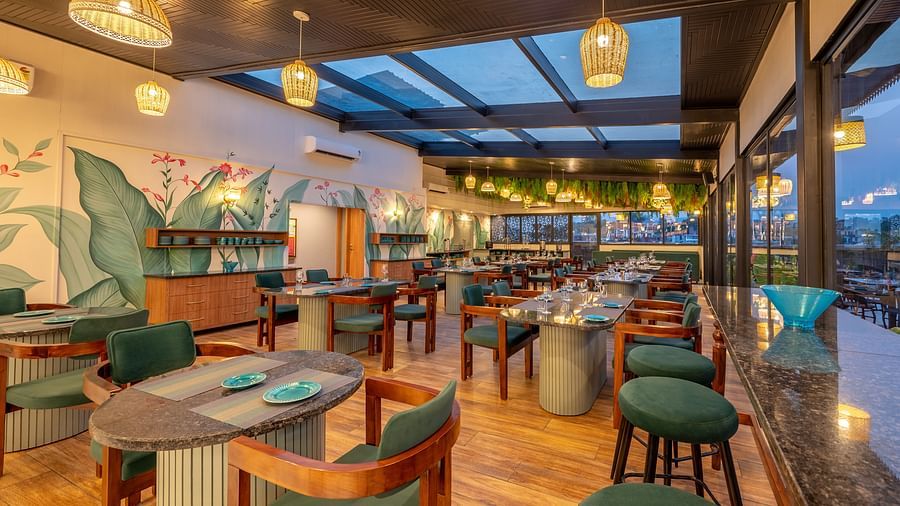 Close up of The Gaia Gourmet restaurant at Vishranti Hotel, Dehradun, featuring a well-lit dining area with wooden floors.