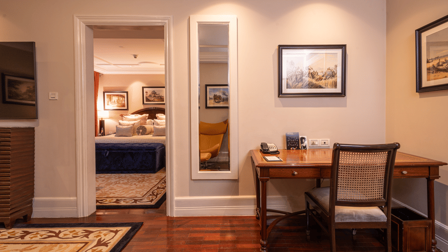 image of a work space with a chair and a full lenght mirror at our regent suite - The Claridges New Delhi
