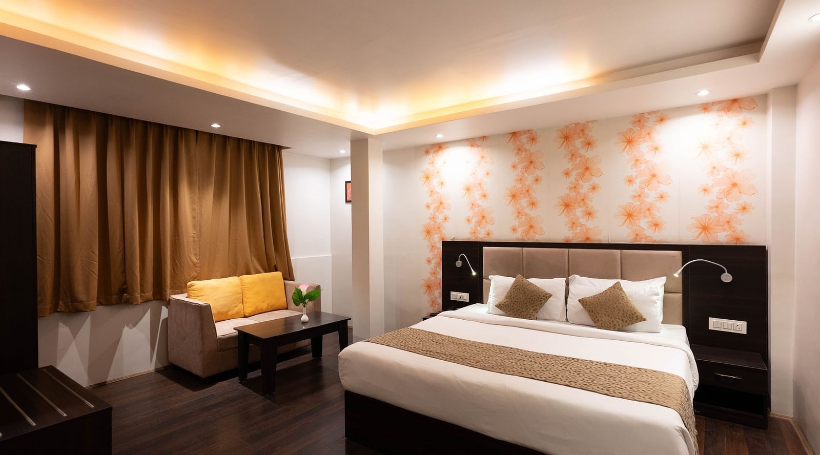 A bedroom featuring a sofa and wooden flooring at Avianna Hungry Jack, Gangtok.