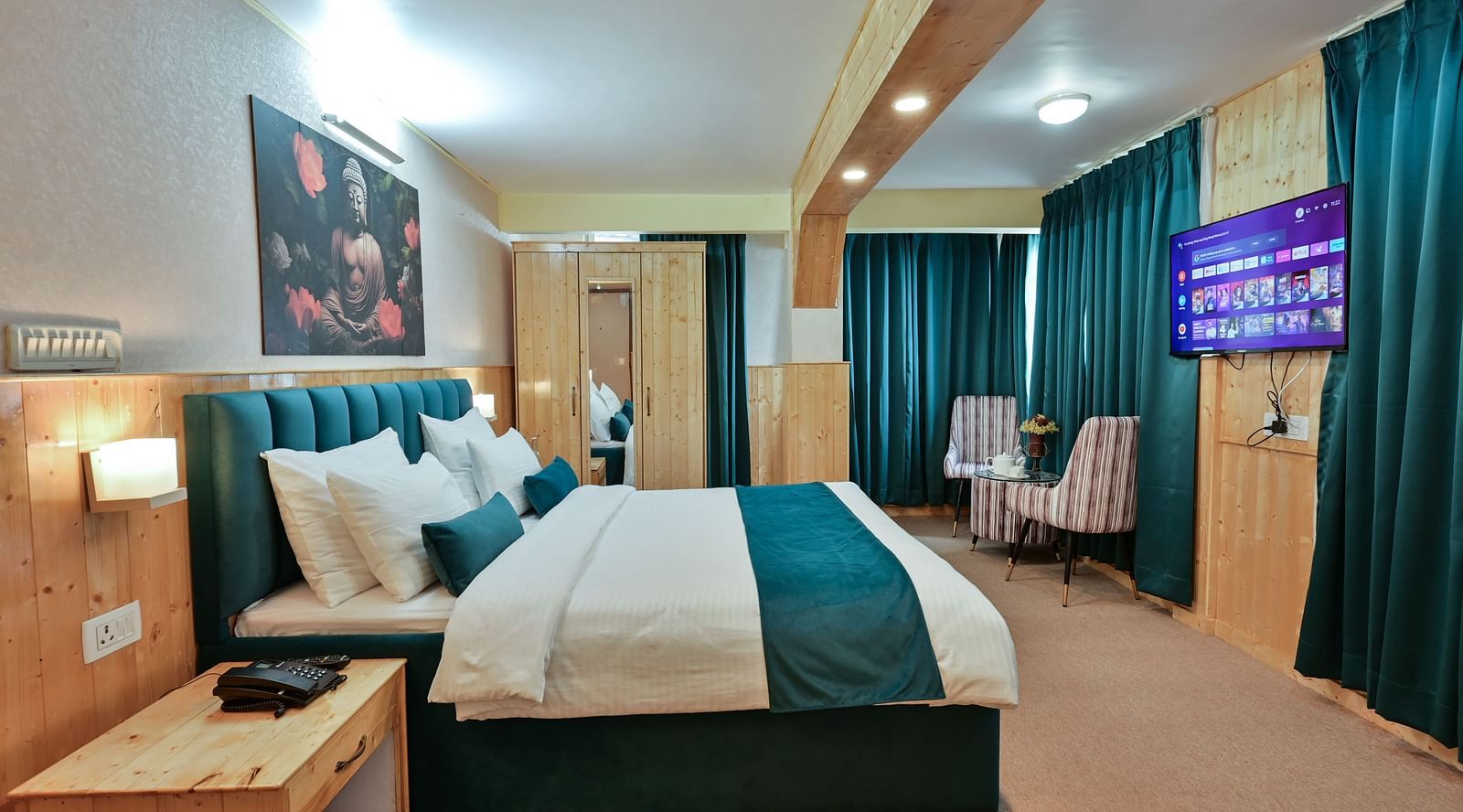 Premium room featuring a king sized bed, wall-mounted television, windows with curtains, and warm lighting at Avianna Seven Seas, Darjeeling6
