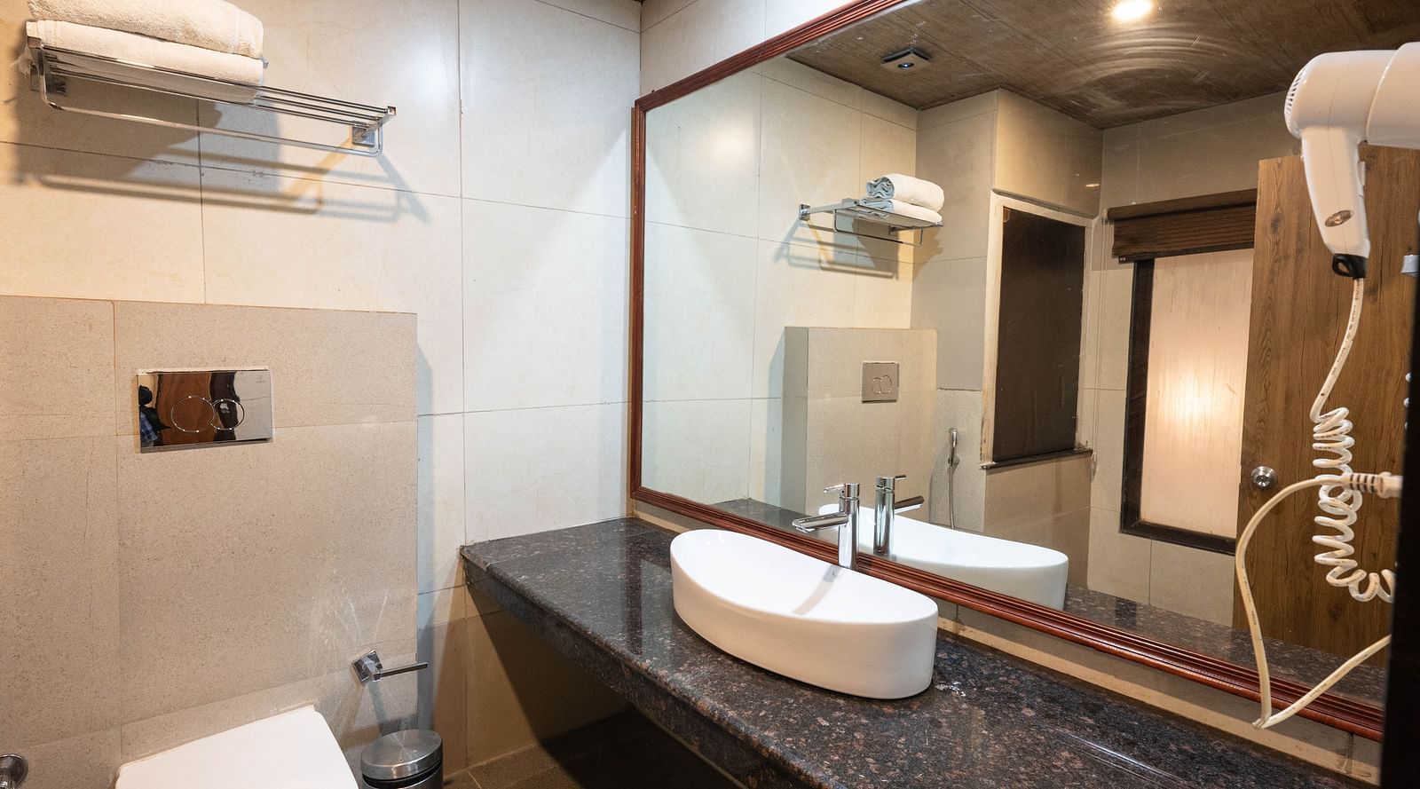 Bathroom equipped with a hair dryer and mirror at Avianna Hungry Jack, Gangtok.