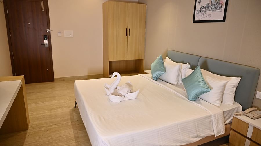Premium room with a large bed, clean be sheets, soft pillows, and a towel swan, with a wardrobe and simple decor at TGI Livancia Hillside