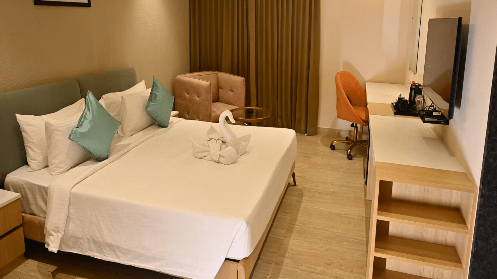 Spacious premium room with a comfy bed, a cosy seating area, and a work desk with a chair - Livancia Hillside