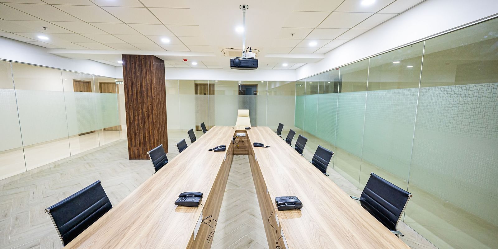 A spacious meeting room featuring a long wooden table and comfortable chairs at Lotus Leaf Boutique Hotel.