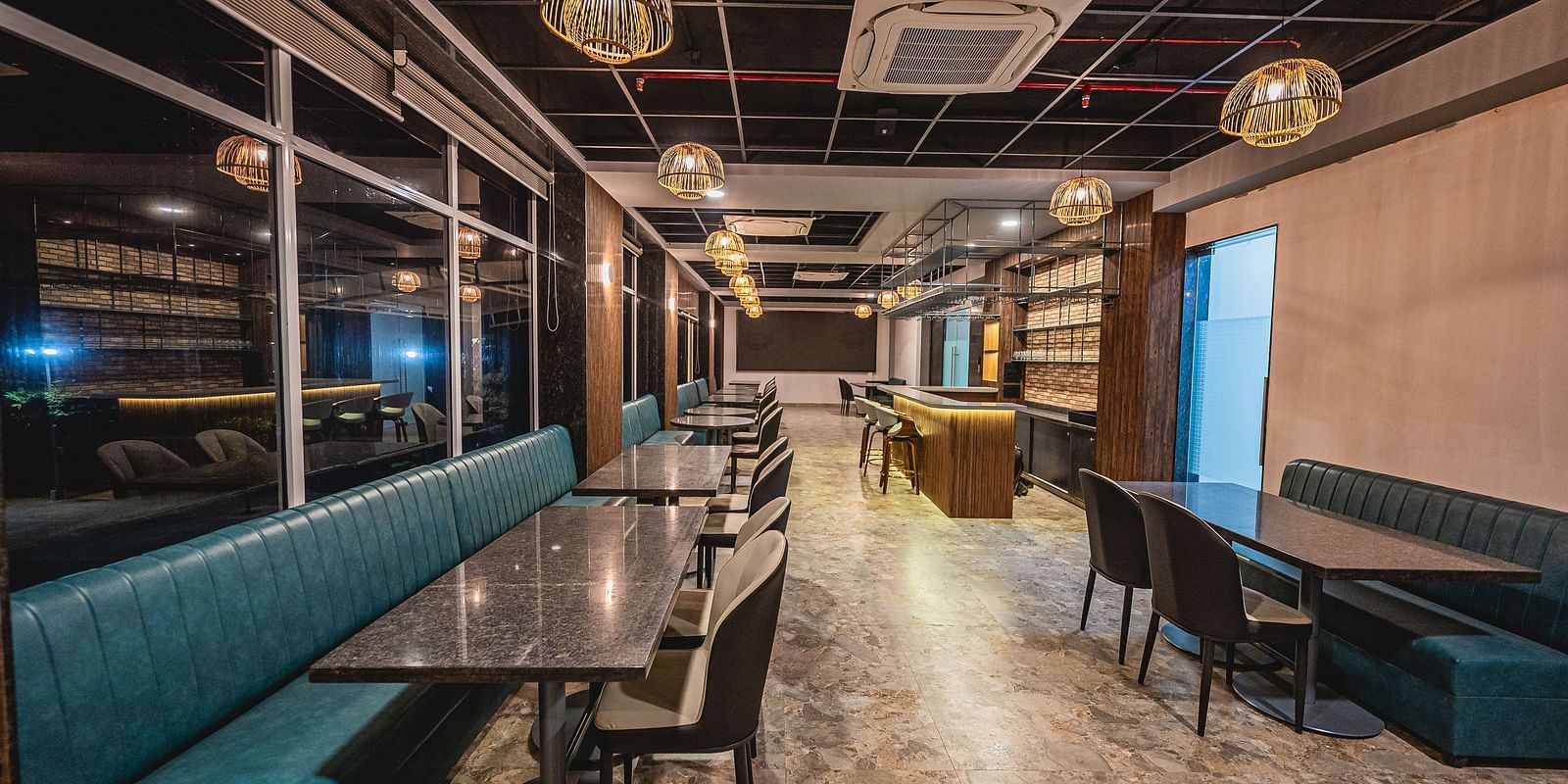 A modern restaurant with cushioned seating and a sophisticated atmosphere at Lotus Leaf Boutique Hotel.