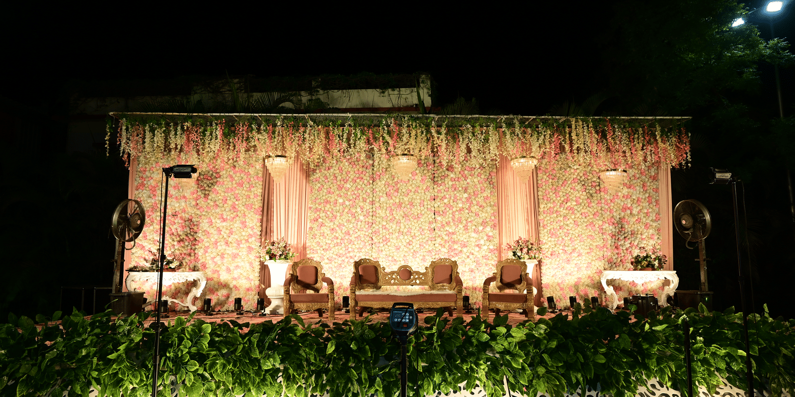 Beautifully decorated stage setup at Fiesta Lawn, Papaya Tree Hotels, designed for evening events and wedding celebrations.