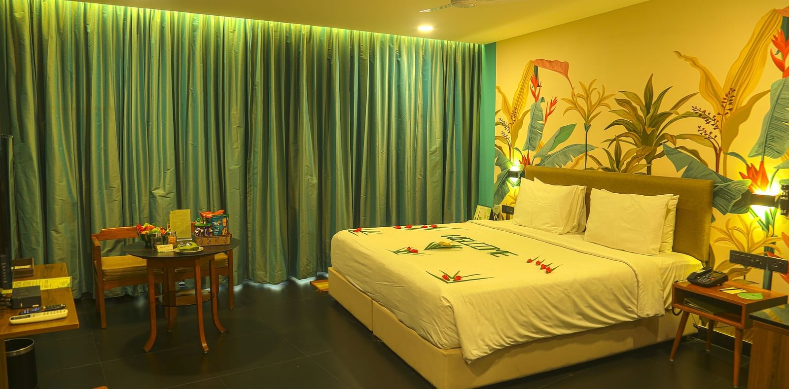 An image of a a valley view room with king size bed, bed side table, wardrobe, air-conditioner, and decorative items - Great Trails Yercaud by GRT Hotels