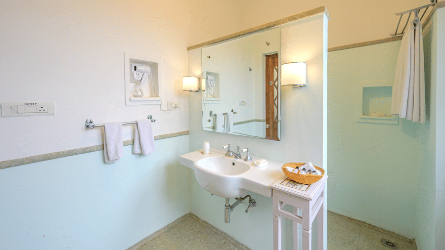 Wall-mounted sink and large vanity mirror in the bathroom of Aruna Vilas at Deo Bagh - 17th Century, Gwalior.