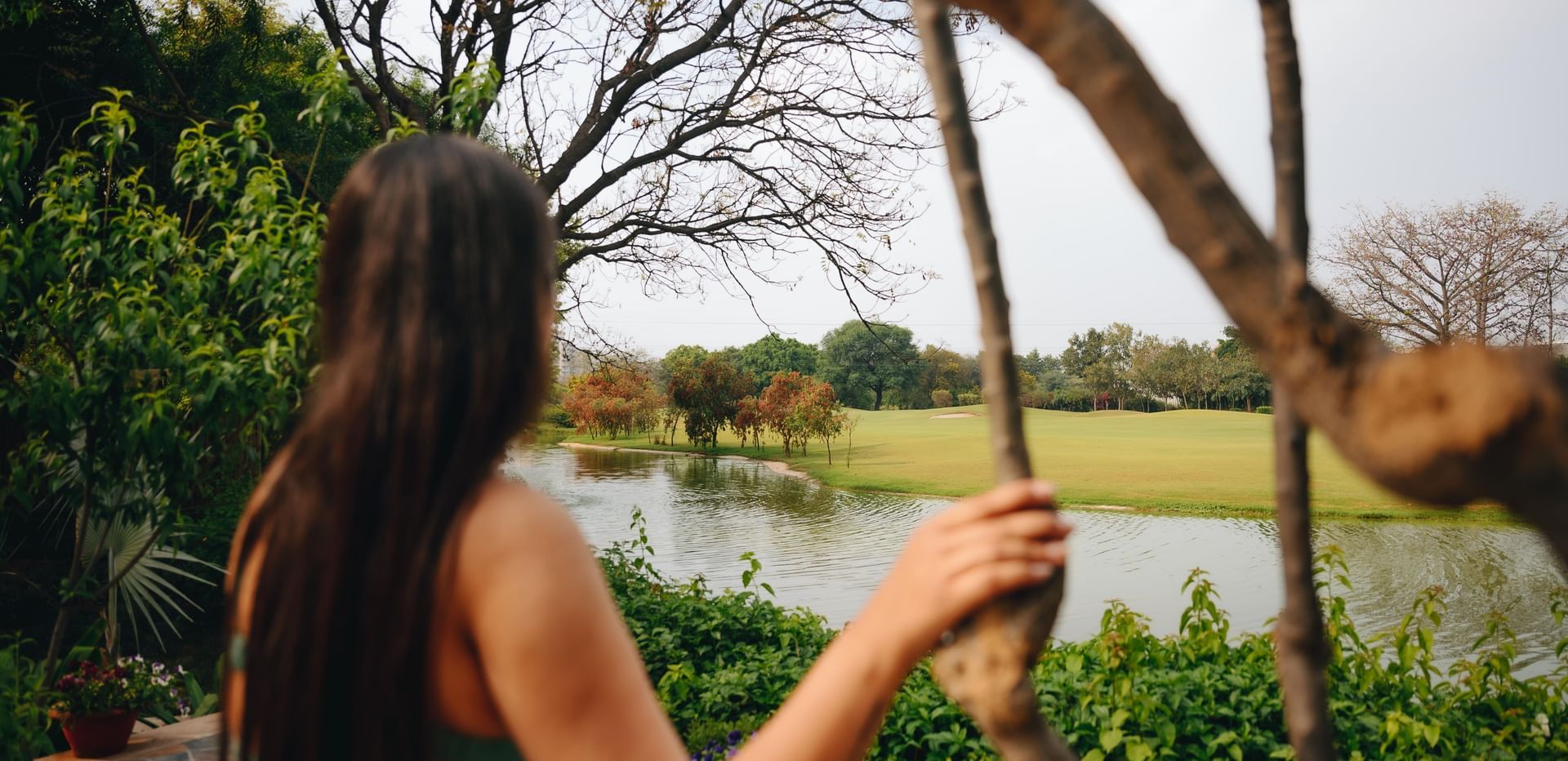 Guest enjoying a scenic view of open fields and greenery from Karma Chalets.