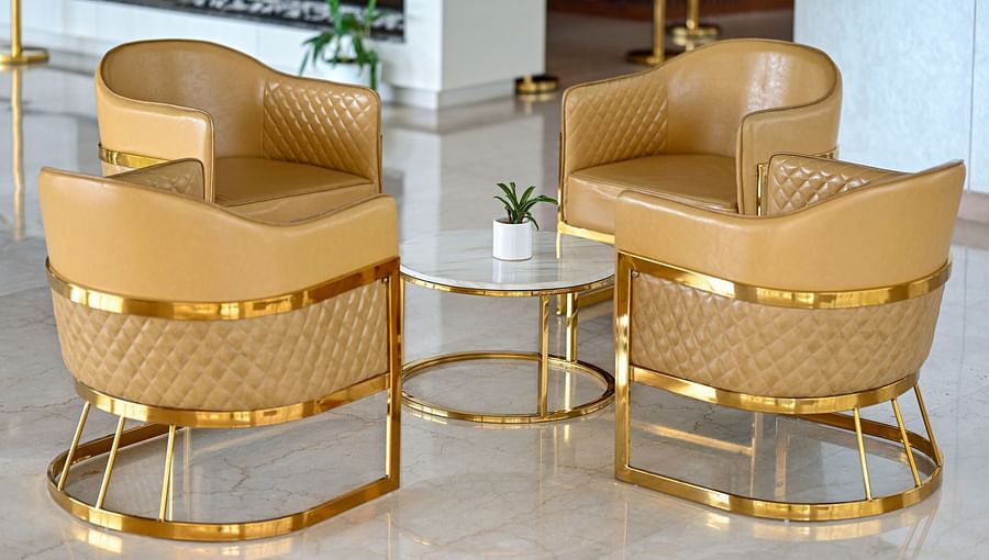 alt-text golden coloured sofa seats at the lobby area