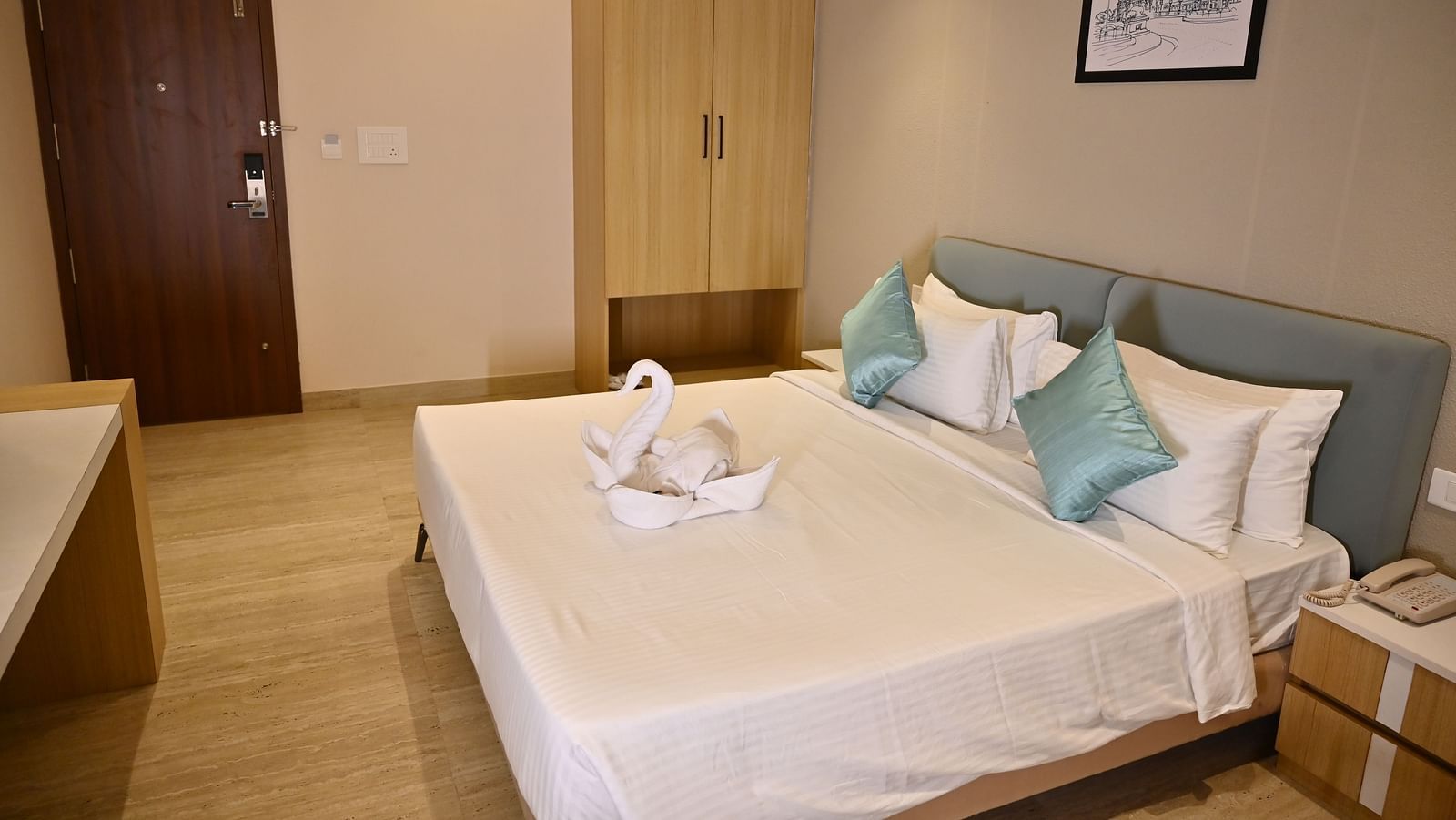 Premium room with a large bed, clean be sheets, soft pillows, and a towel swan, with a wardrobe and simple decor at TGI Livancia Hillside