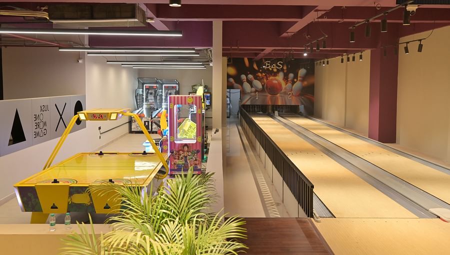 A huge hall divided into two—one side with arcade machines, the other a bowling alley - Clarks Safari, Haridwar