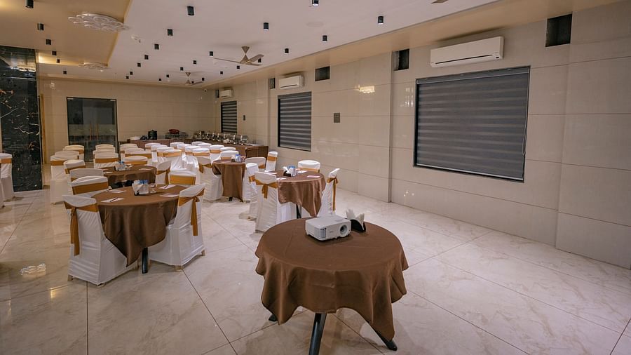 Round table setup with covers, fan, ac and chairs at Clarks Collection Somnath.