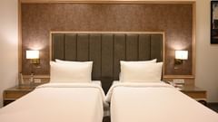 A close up shot of the twin beds setup in one of our rooms in Ajmer - Sarovar Portico, Ajmer