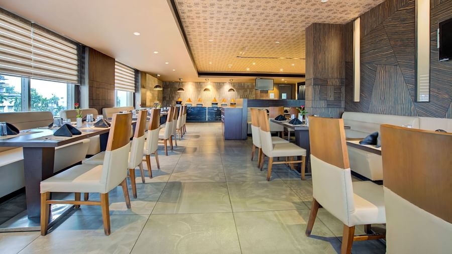 Modern indoor restaurant with elegant seating and ambient lighting at Voyage Milestone Hotel and Banquet Siliguri