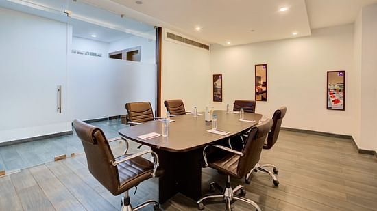 Bright and minimal meeting room designed for corporate discussions and business presentations at Voyage Milestone Hotel and Banquet Siliguri
