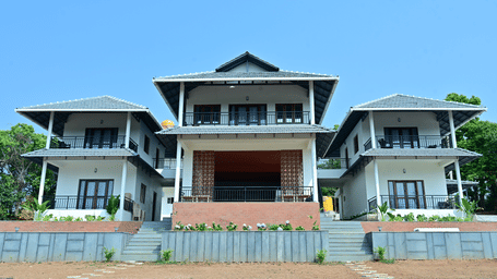 3 multi-storey building facades of Aarika Resort & Hotels with tiled roofs.