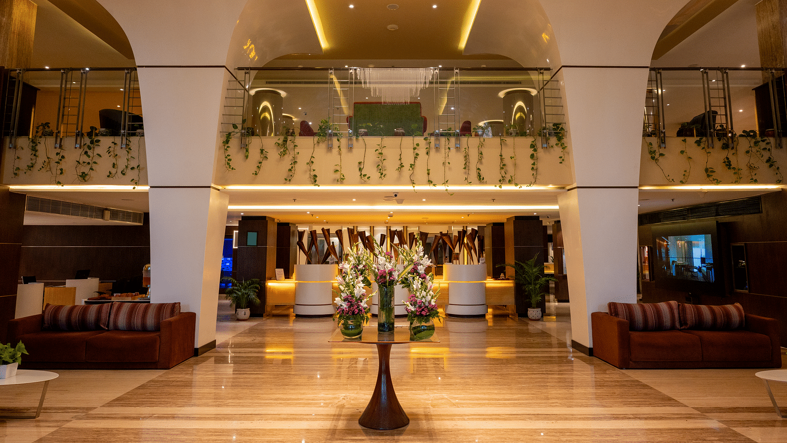 An image of lobby with a huge chandelier at Grand Kakinada by GRT Hotels