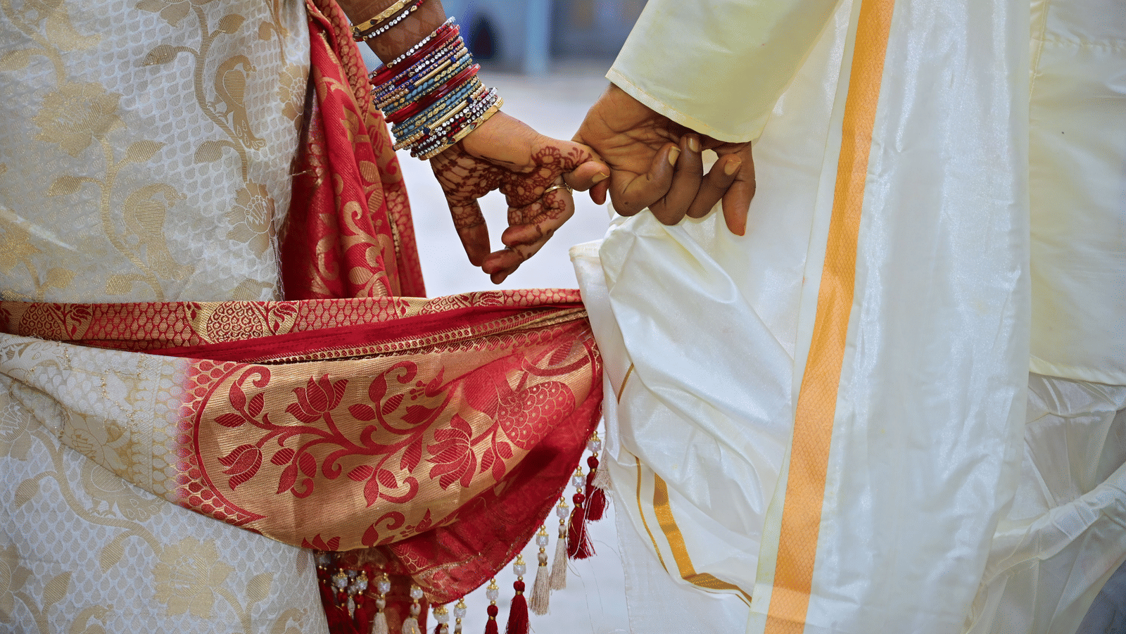 A close up view of a couple's hands during their wedding day.