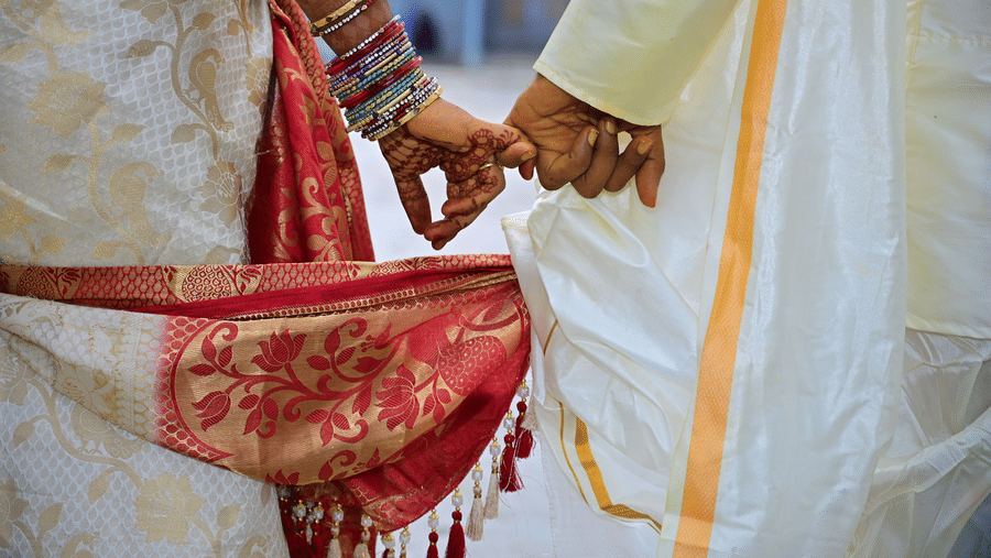 A close up view of a couple's hands during their wedding day.