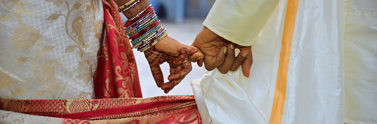 A close up view of a couple's hands during their wedding day.