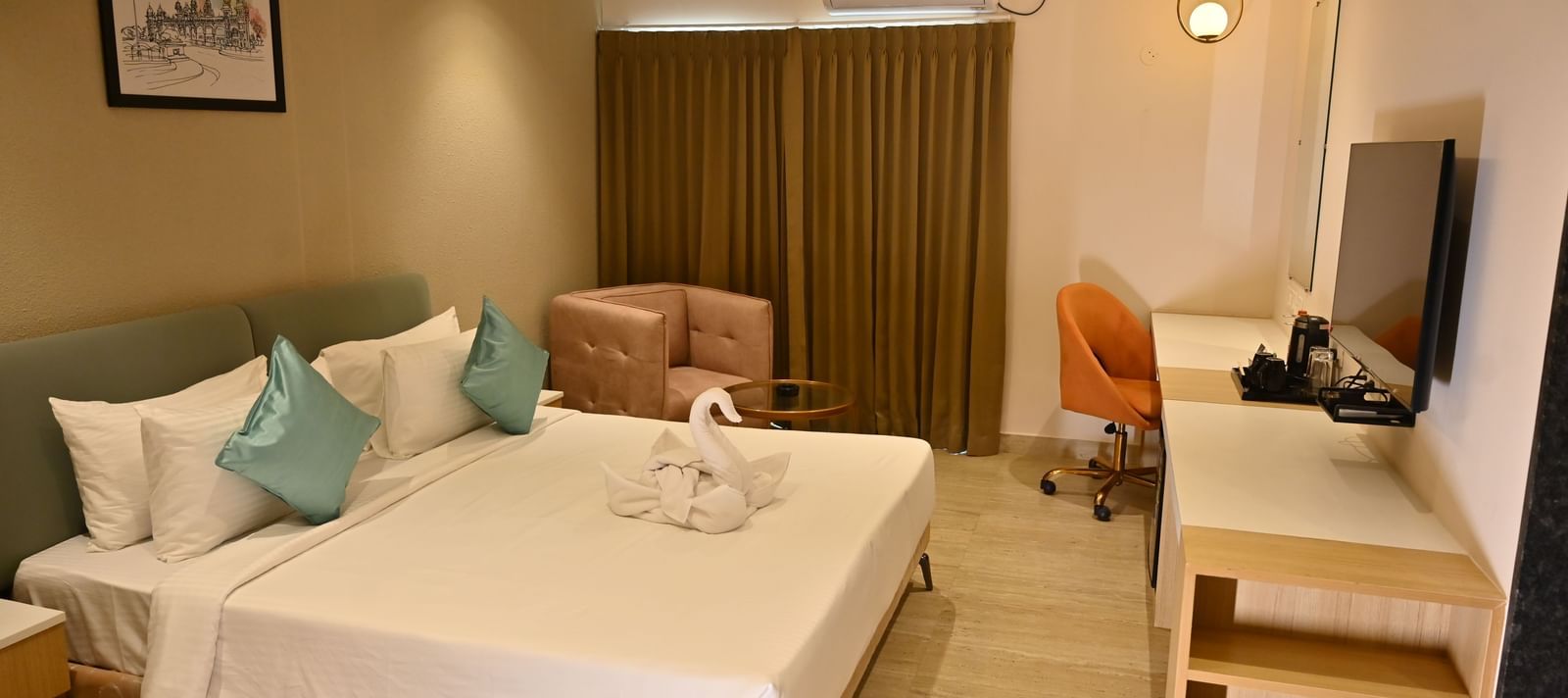 Bedroom at TGI Livancia Hillside with a towel art on a king bed, cupboard, TV and curtained windows.