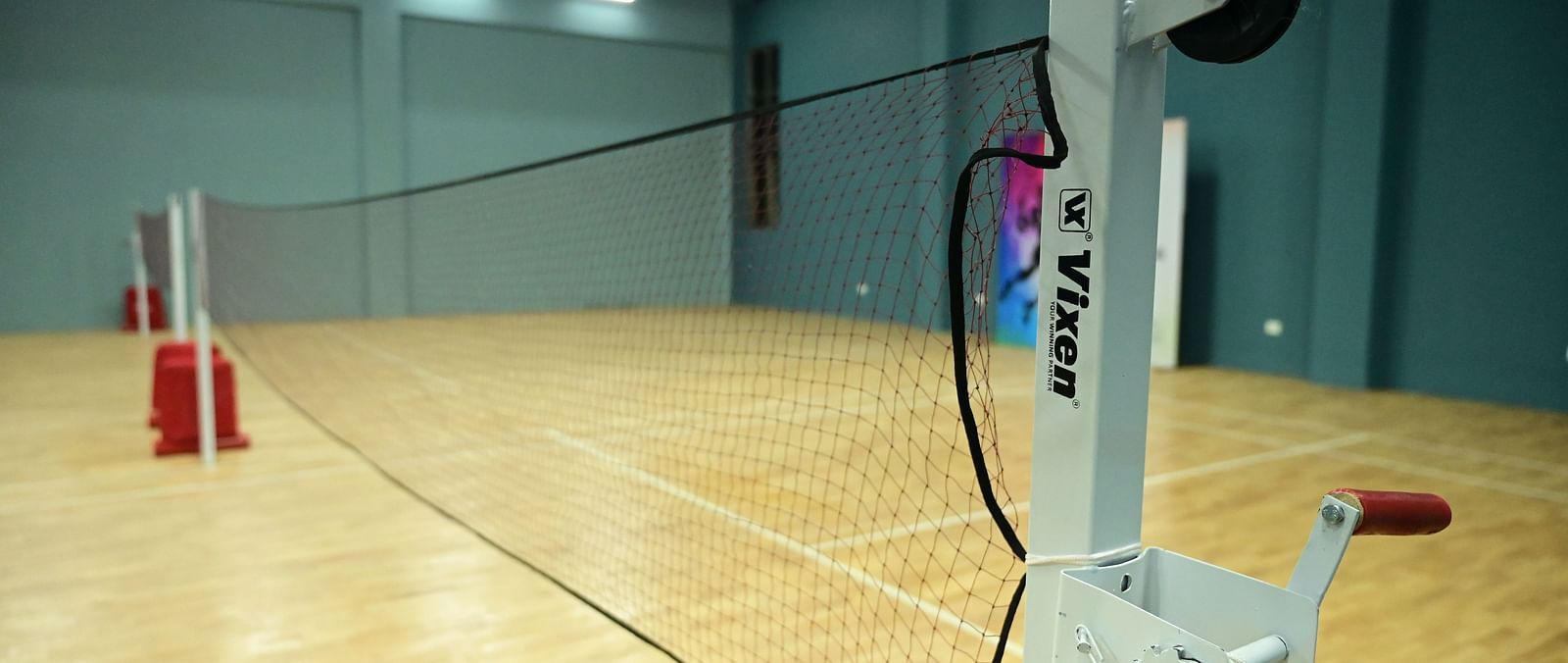 close up image of the badminton net placed in the badminton court at club charholi, pune