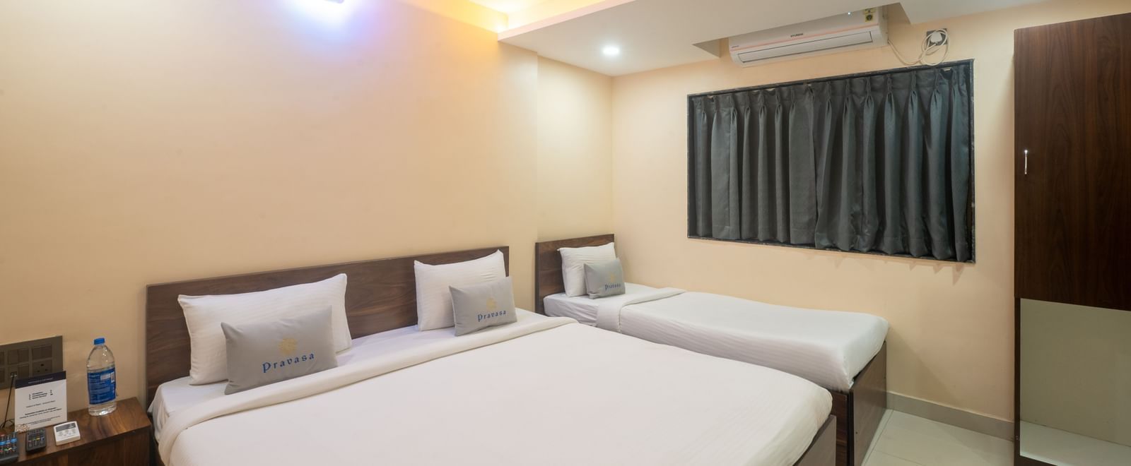A room at Pravasa Stay, Shirdi, is a triple occupancy space with a double bed and a single bed.
