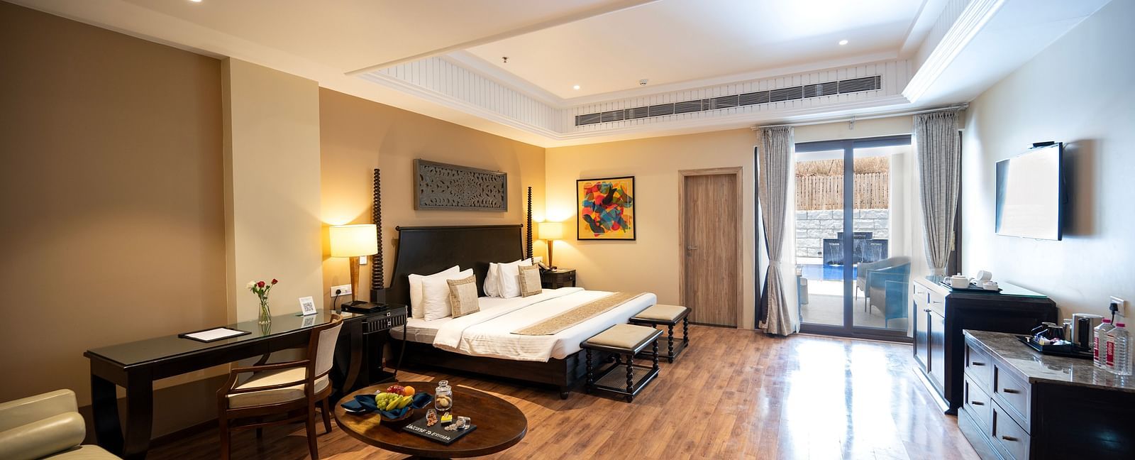 Presidential suite a king size bed placed in front of a TV at Essentia Luxury Resort & Spa, Udaipur.