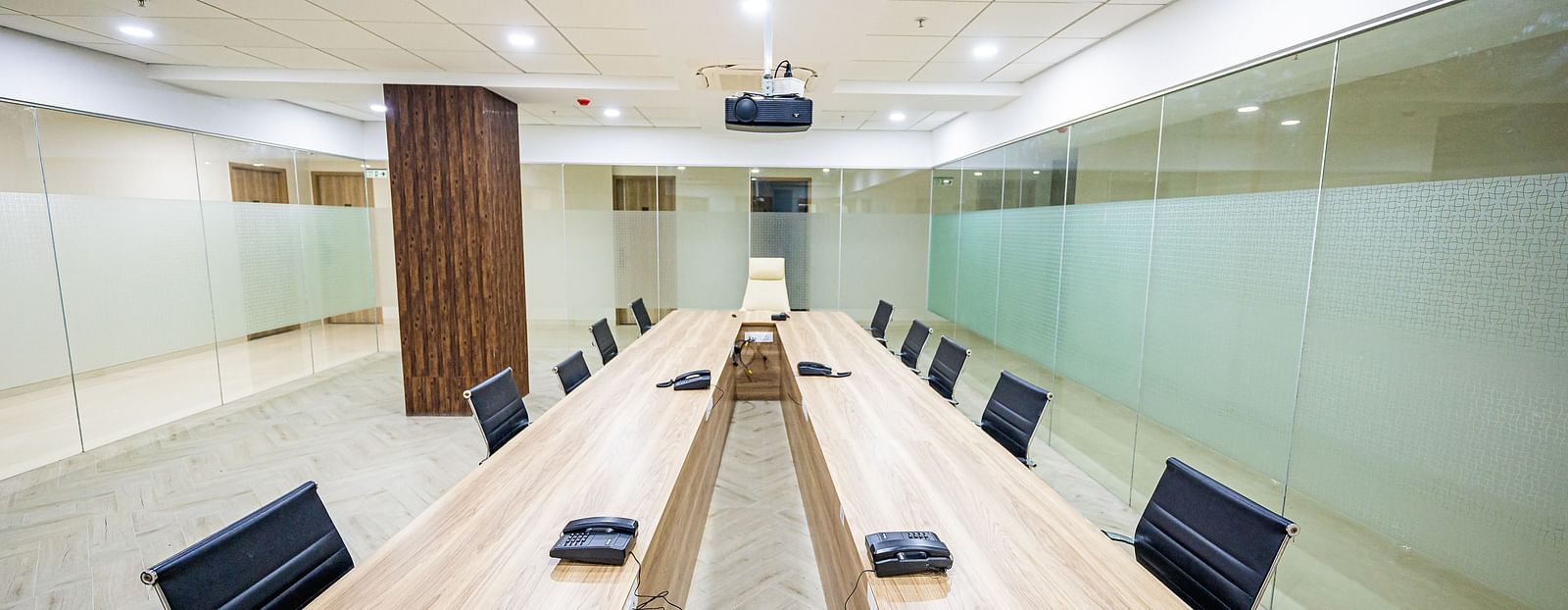 A spacious meeting room featuring a long wooden table and comfortable chairs at Lotus Leaf Boutique Hotel.
