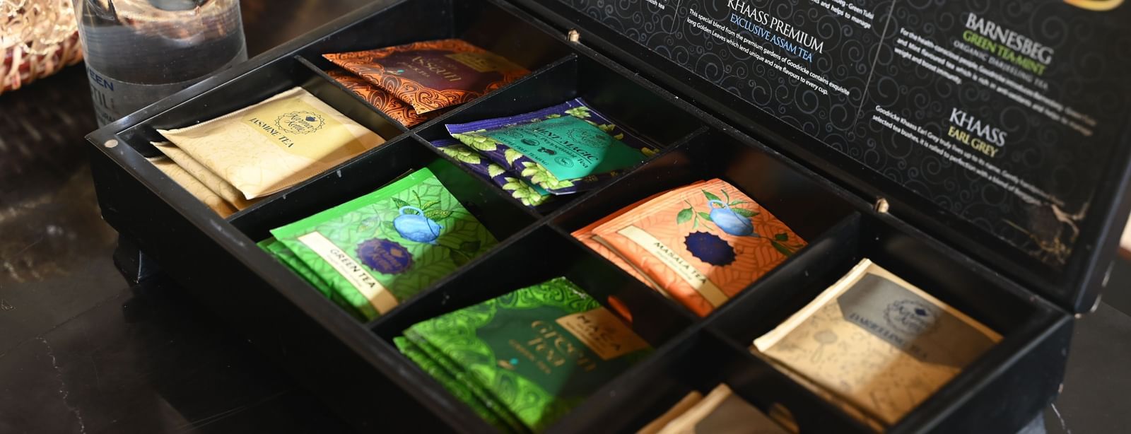  A black box reveals an assortment of colourful tea bags or spices in individual compartments | Vedic Village Spa Resort, Kolkata