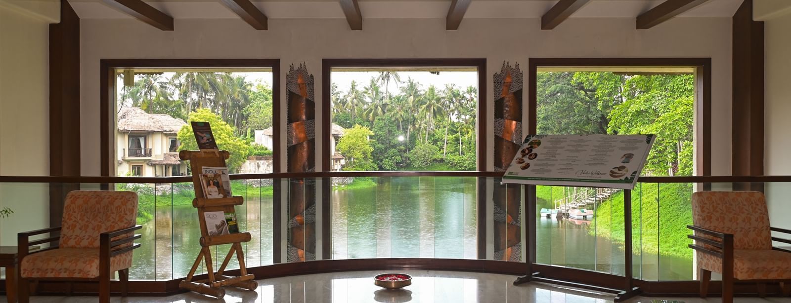 Spa reception Lobby in Vedic Village Spa Resort, featuring a lake view and comfortable seating.