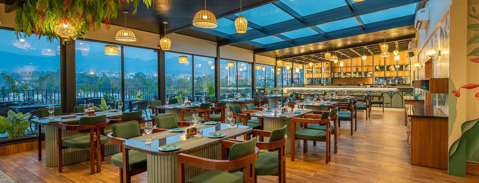 Interior of The Gaia Gourmet restaurant at Vishranti Hotel, Dehradun, featuring a well-lit dining area with wooden floors.