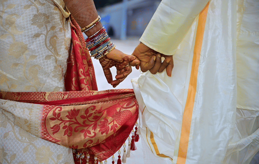 A close up view of a couple's hands during their wedding day.