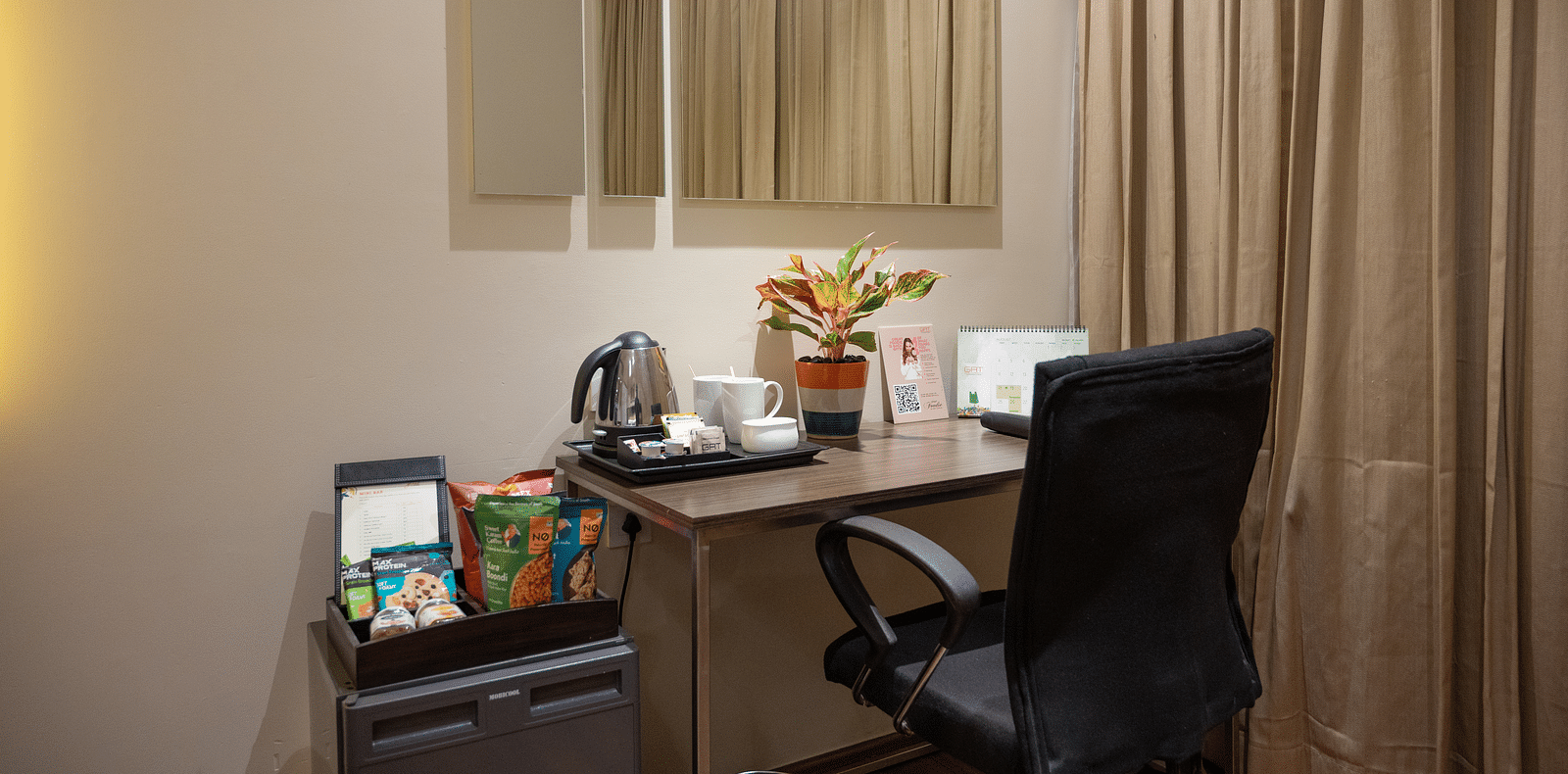 An image of writing table and a chair at Grand Kakinada by GRT Hotels