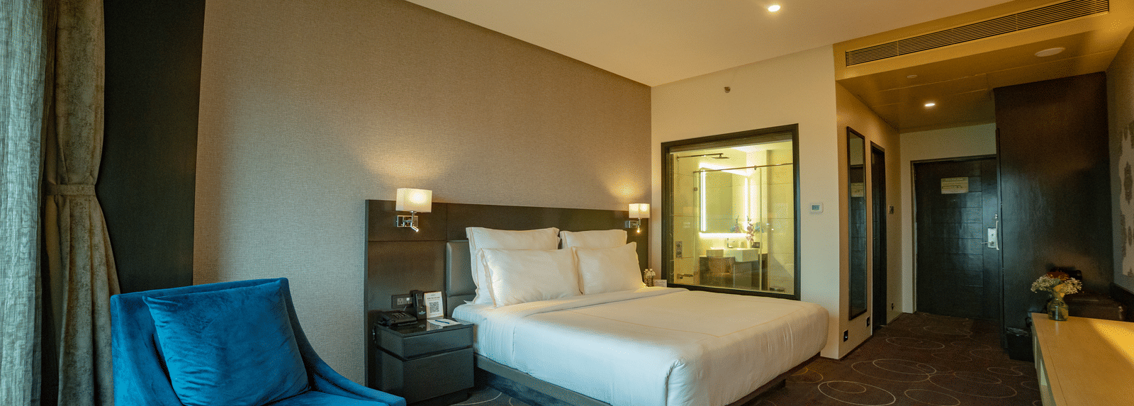 Spacious suite with elegant furnishings and cosy ambience at Narayani Heights Hotel & Resorts, Ahmedabad.
