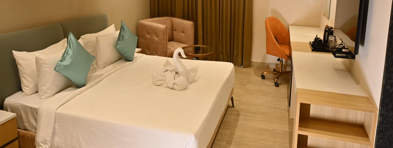 Spacious premium room with a comfy bed, a cosy seating area, and a work desk with a chair - Livancia Hillside