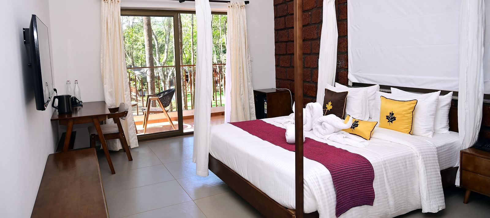 An image of a Premium Cottage featuring a poster bed, a flat TV screen, a work desk and chair, and a balcony - TGI Redolent Resort, Kushalnagar, Coorg