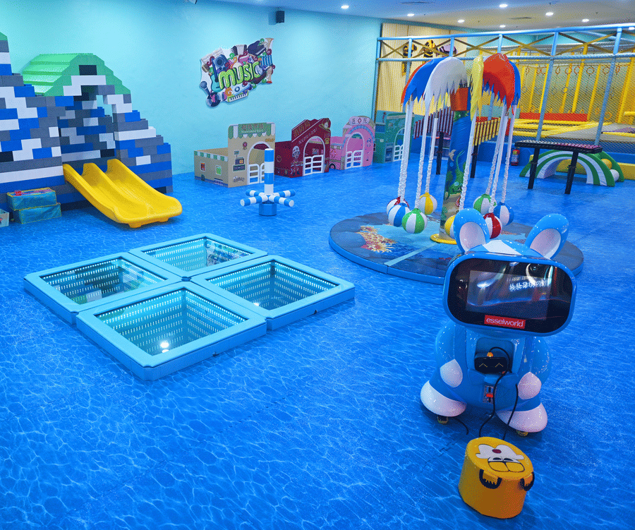 Indoor playground with slides, climbing frames, and a robot toy, featuring a bright and playful design.