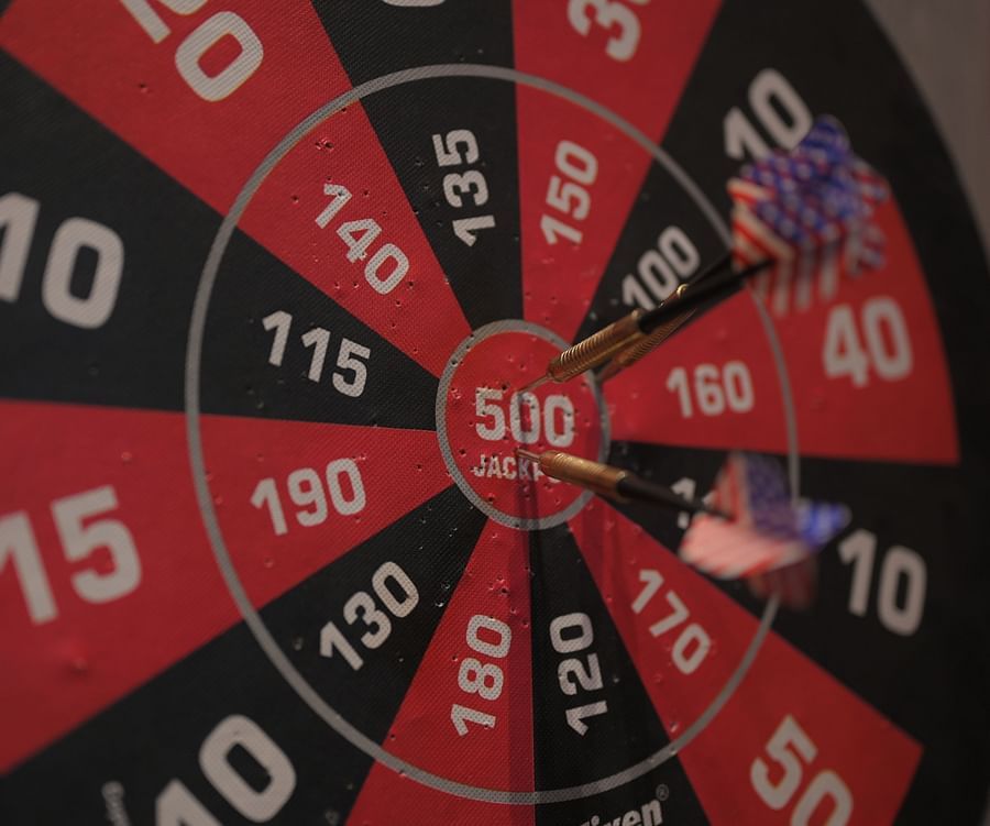A close-up shot of a dart board with two darts stuck on the bull’s eye 500 pointer - Clarks Safari, Haridwar