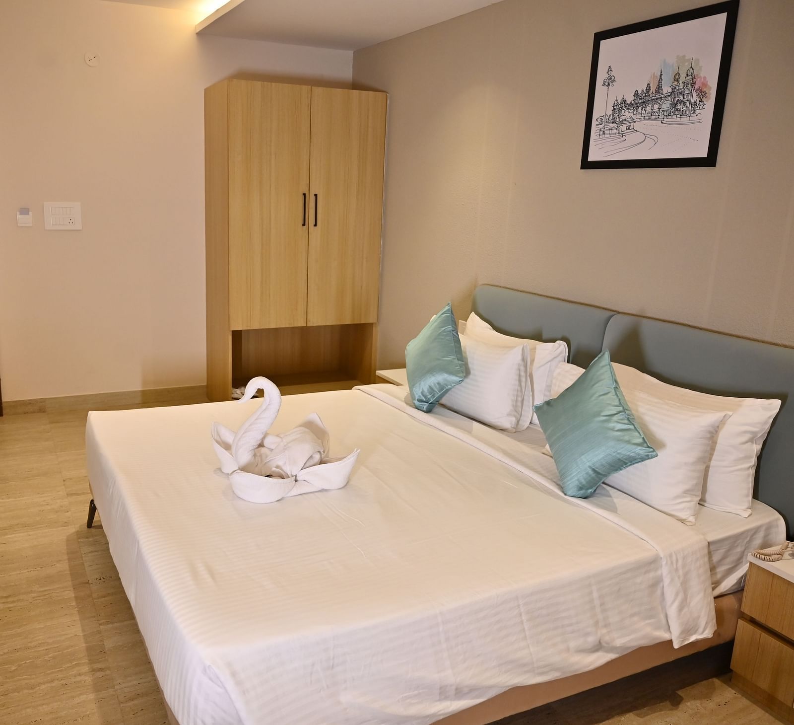 Premium room with a large bed, clean be sheets, soft pillows, and a towel swan, with a wardrobe and simple decor at TGI Livancia Hillside