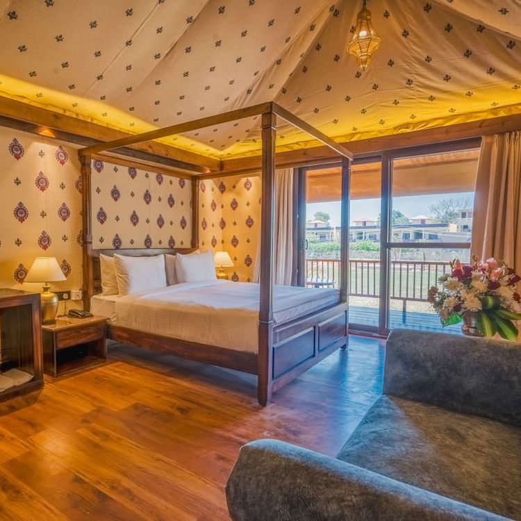 A Premium Duplex Tent featuring  a plunge swimming pool, a sofa set, with centre table, and a flight of wooden stairs at The Baagh Ananta Elite, Ranthambore