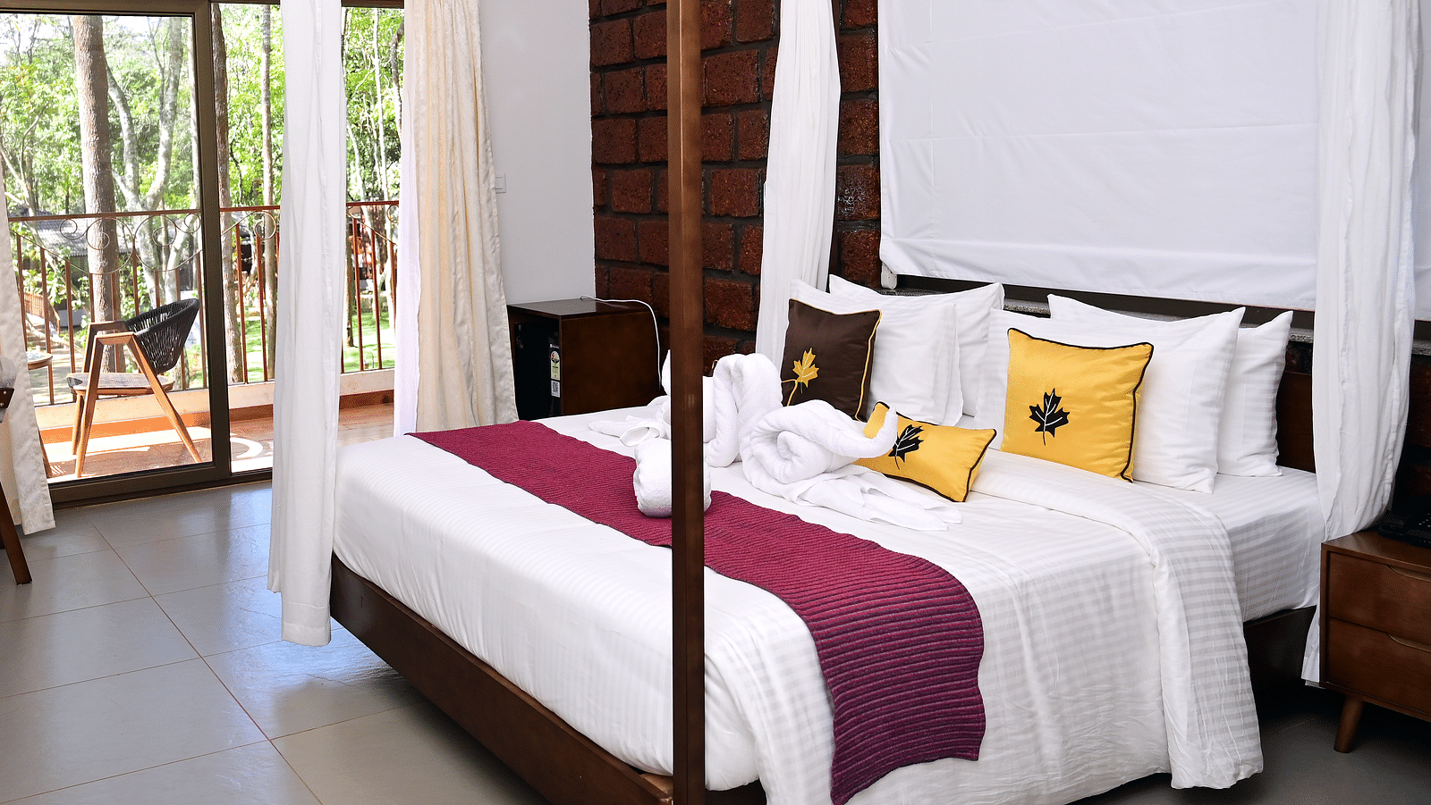 An image of a Premium Cottage featuring a poster bed, a flat TV screen, a work desk and chair, and a balcony - TGI Redolent Resort, Kushalnagar, Coorg