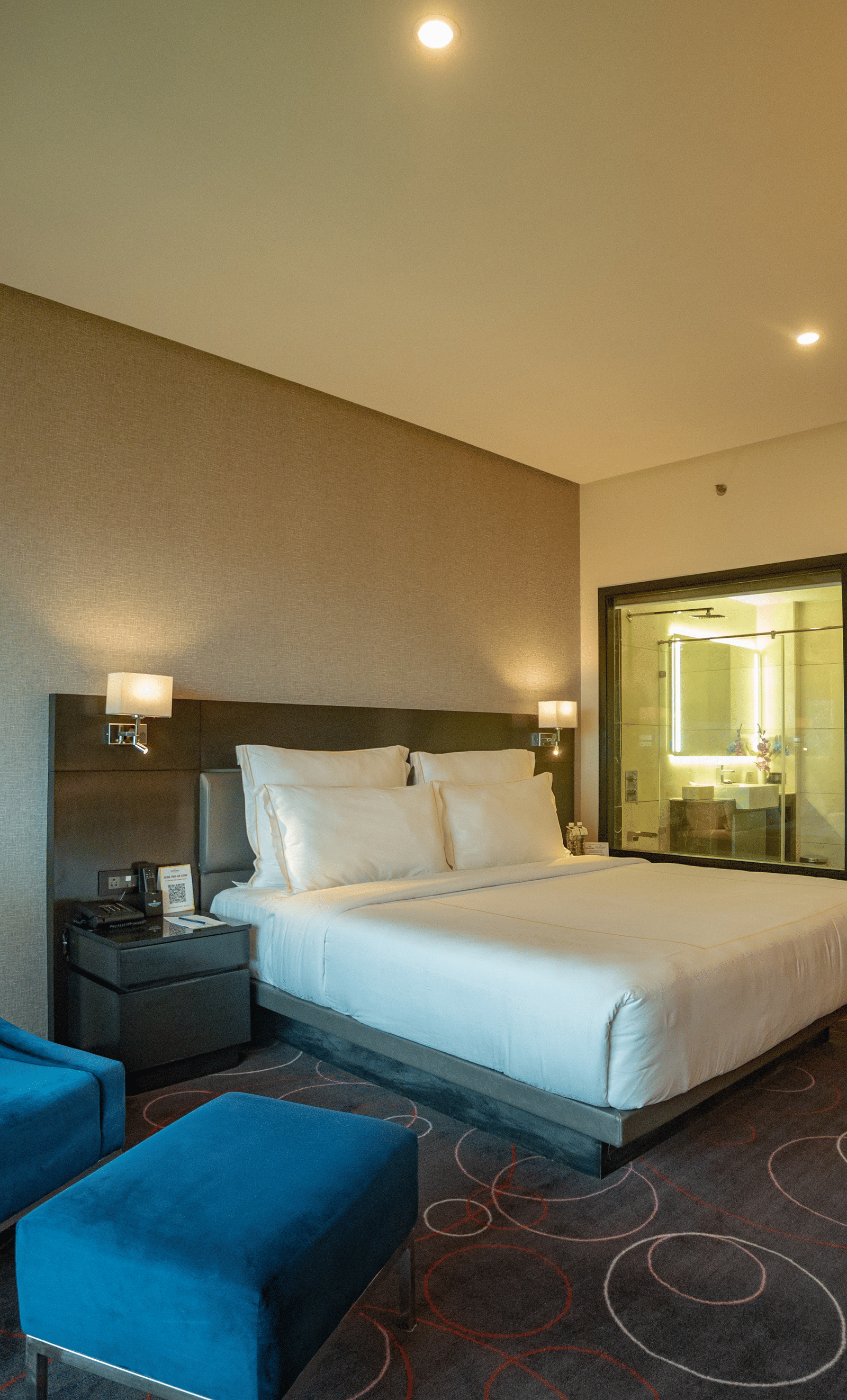 Spacious suite with elegant furnishings and cosy ambience at Narayani Heights Hotel & Resorts, Ahmedabad.