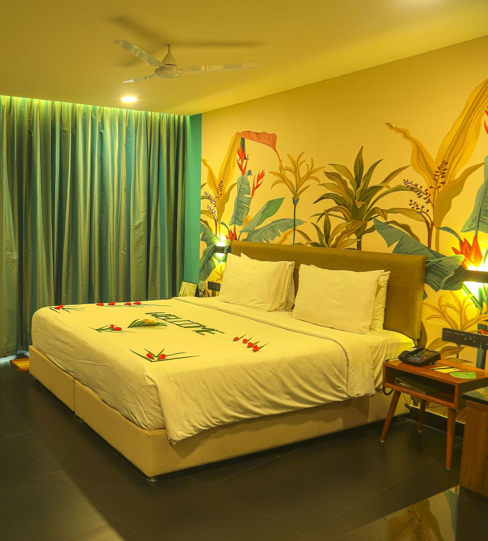 An image of a a valley view room with king size bed, bed side table, wardrobe, air-conditioner, and decorative items - Great Trails Yercaud by GRT Hotels
